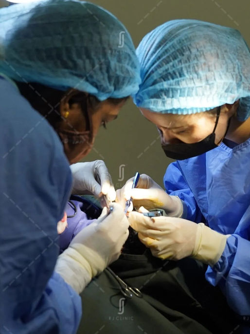 Medical team performing hair transplant procedure at RJ Clinic