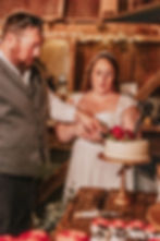 Bride and Groom cutting wedding cake in Barn Wedding Venue in Westminster, MD