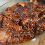 A tray of dark Kvass Croissant pudding looking glossy, sweet and delicious.