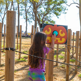 Girl playing pumpkin game at a fall festival activity