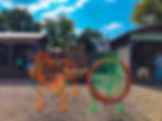 Two colorful wire cow sculptures with hula hoops at an outdoor fair