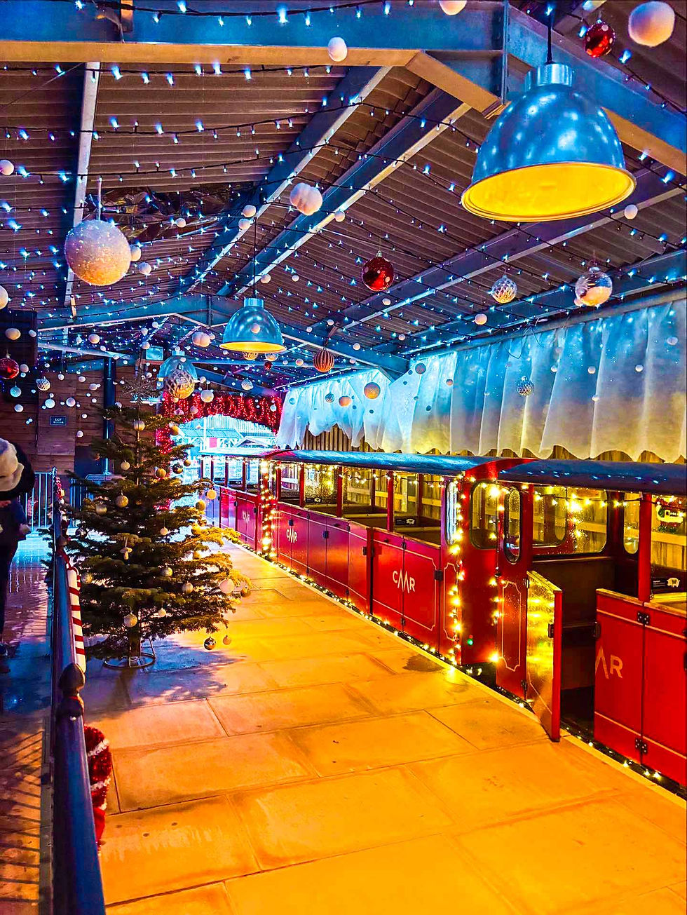 Christmas decorated train station with lights, ornaments, and lights