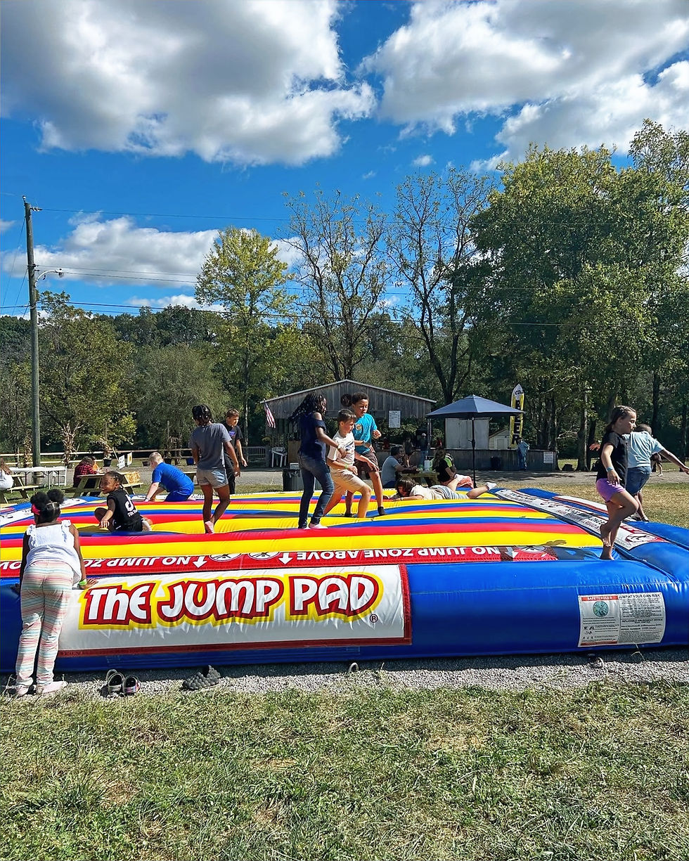 Children playing on The Jump Pad at a Fall Festival.