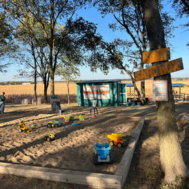 Children's sandbox with toy trucks at the Fall Festival