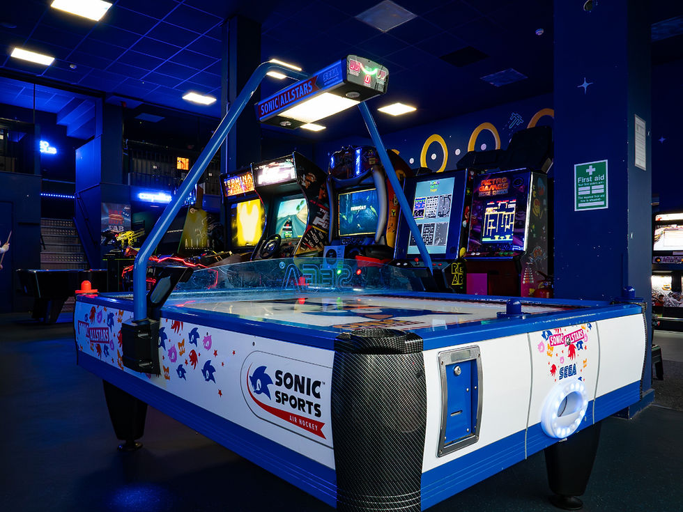 Sonic Sports air hockey table in a neon-lit arcade.