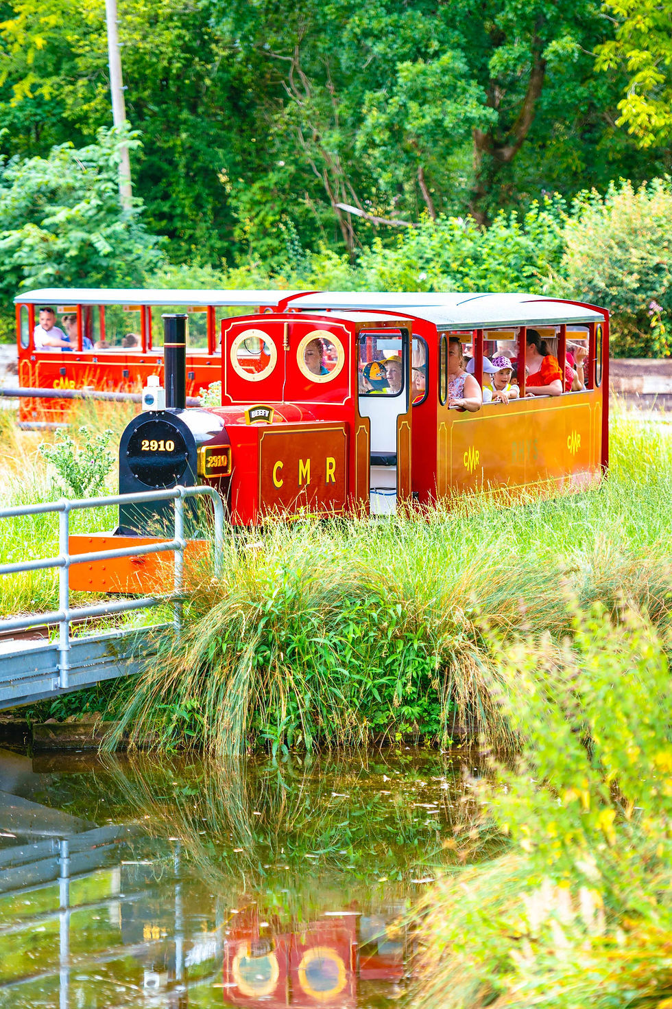 a train riding over a pond