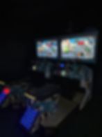 Arcade racing game machine with two screens, seats, and blue lights.