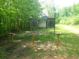 Outdoor axe throwing targets in a wooded area, a possible activity for weekend trips from Knoxville TN.