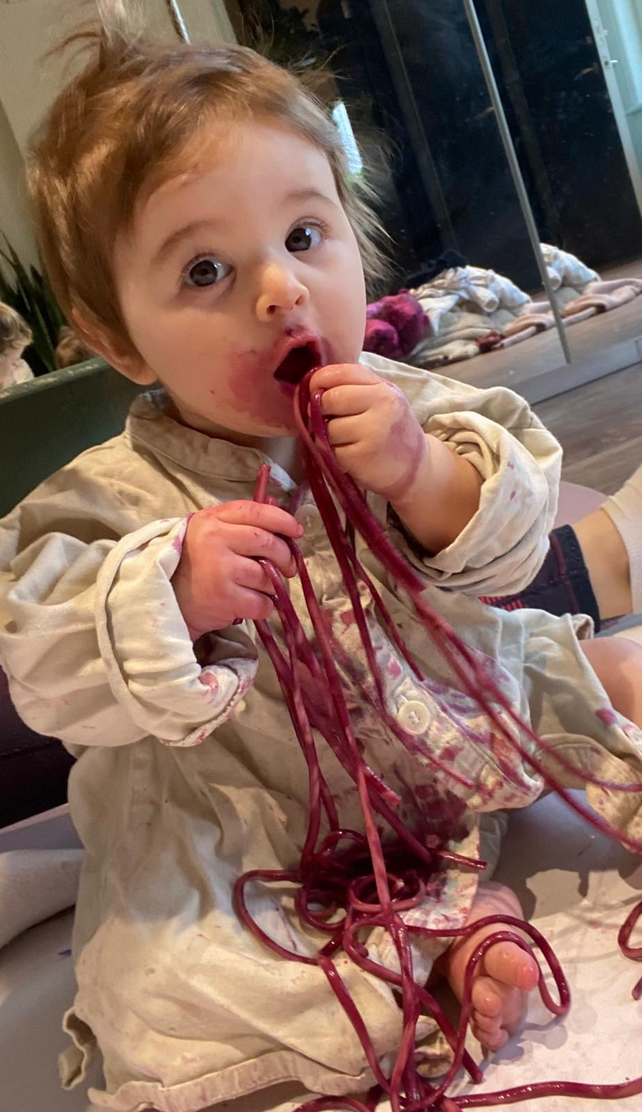 A child using spaghetti as messy play