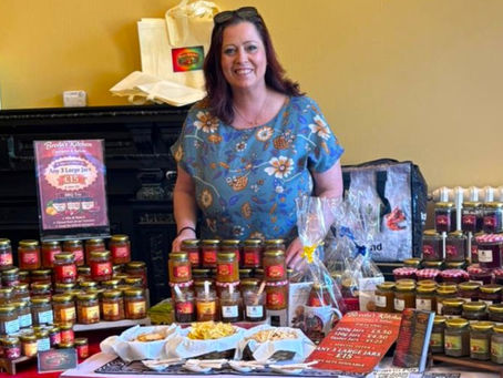 Breda stood behind a table with her jars of chutney displayed on it.