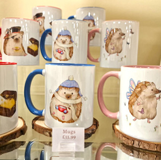 shelves with collection of mugs with illustrations of hedgehogs printed on them