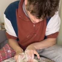 Reece Crawford throwing a pot on a potters wheel