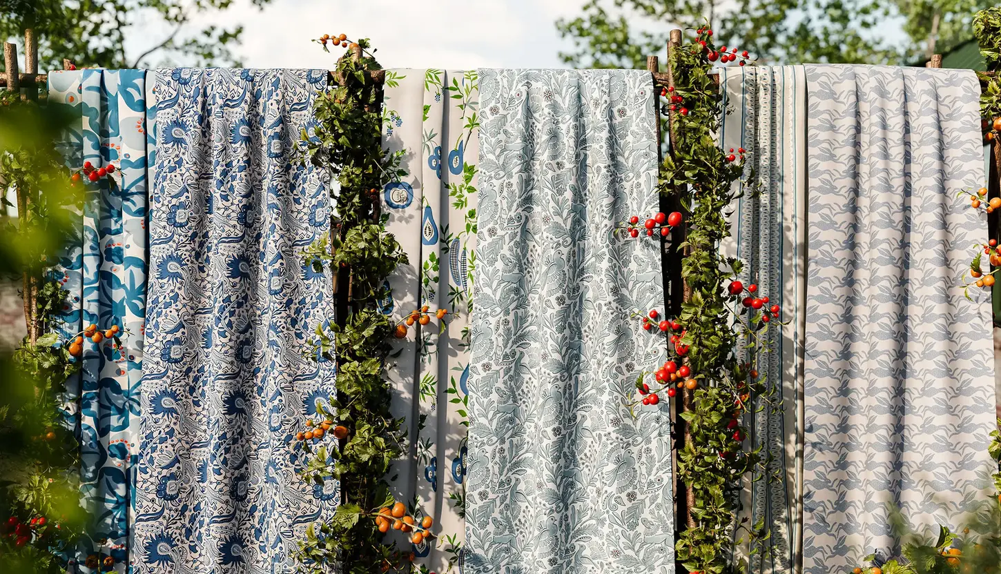 scion pamona luxury British wall coverings_wallpaper hanging in a garden among bean plants