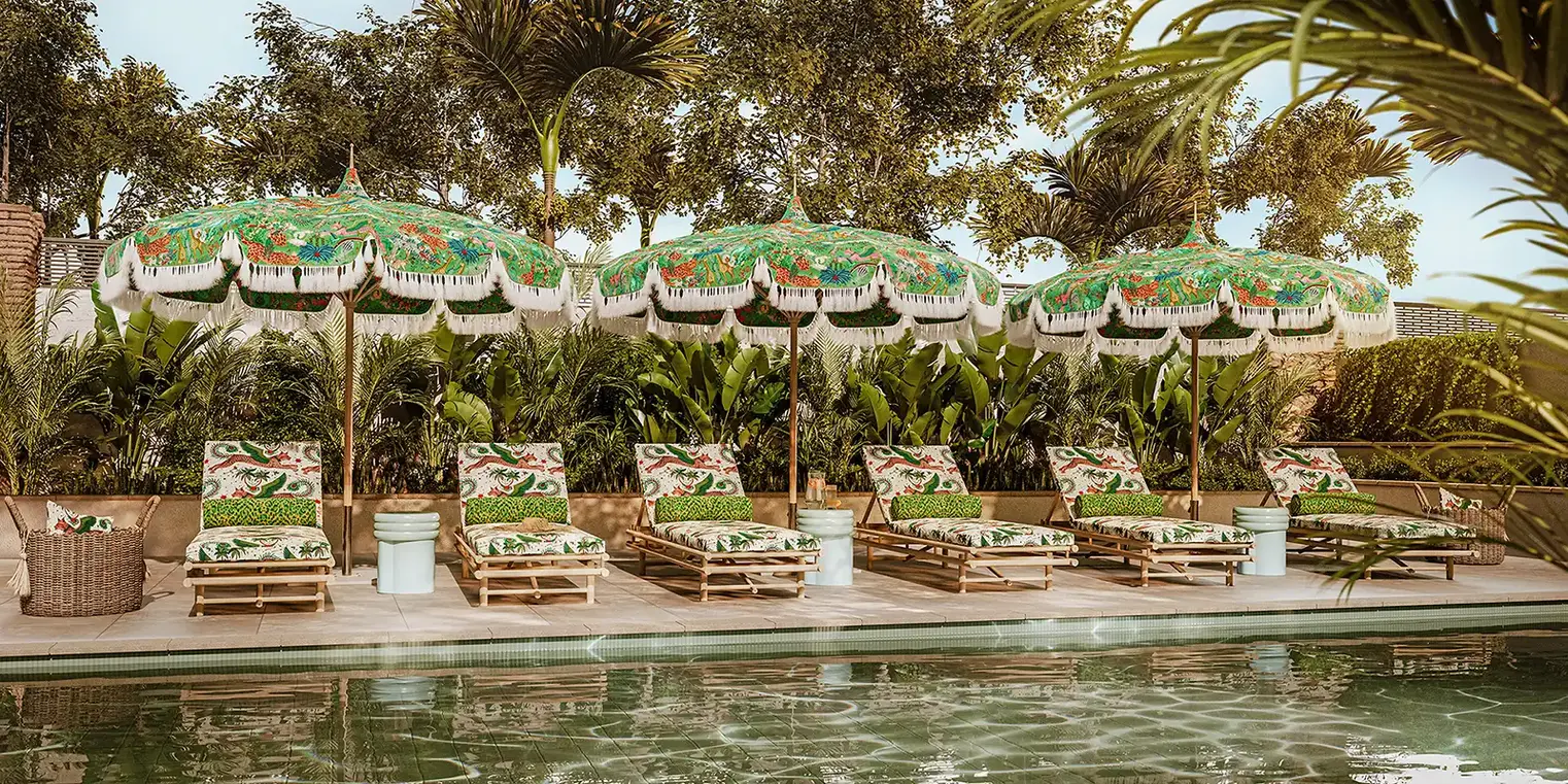 clarke and clarke emma shipley wild escapes indoor outdoor fabrics ss26 on parasols beside a pool