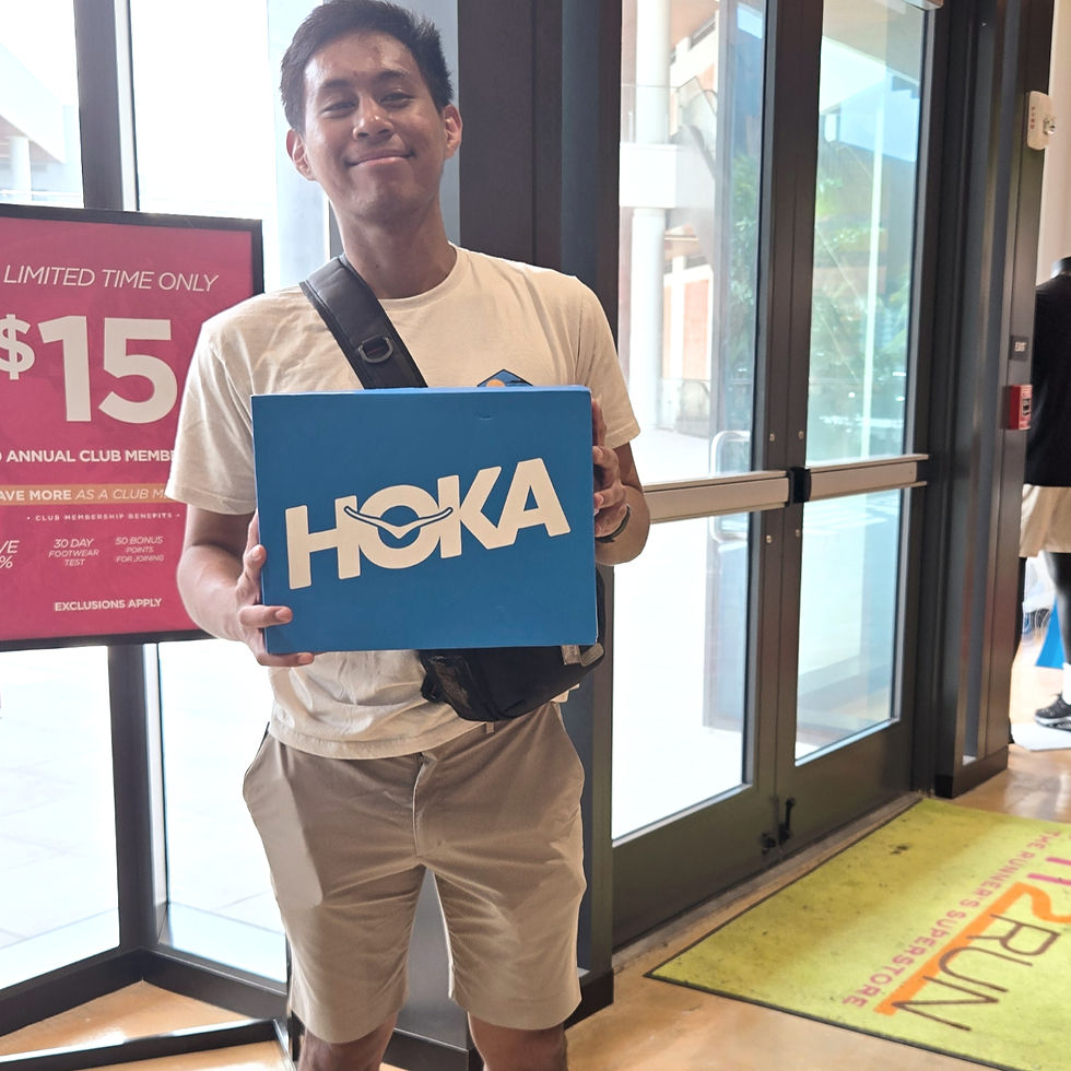 Ready for the next challenge: Proudly holding a new pair of running shoes at the store, geared up for another exciting run.