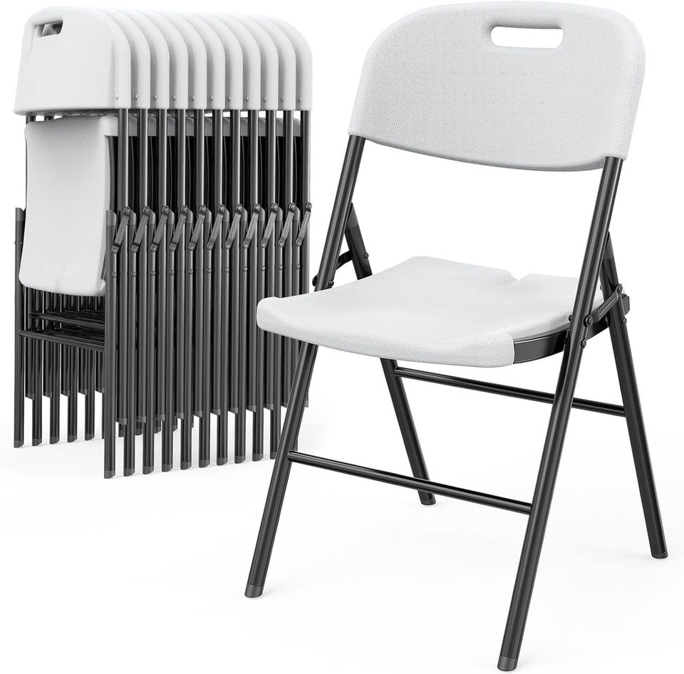 Stack of white folding chairs and one chair set up.