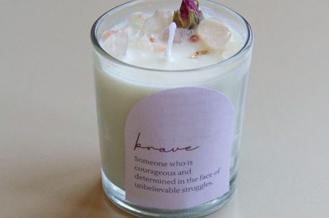 A candle with a quote about bravery, symbolizing support for those facing infertility struggles, suitable for gifting.