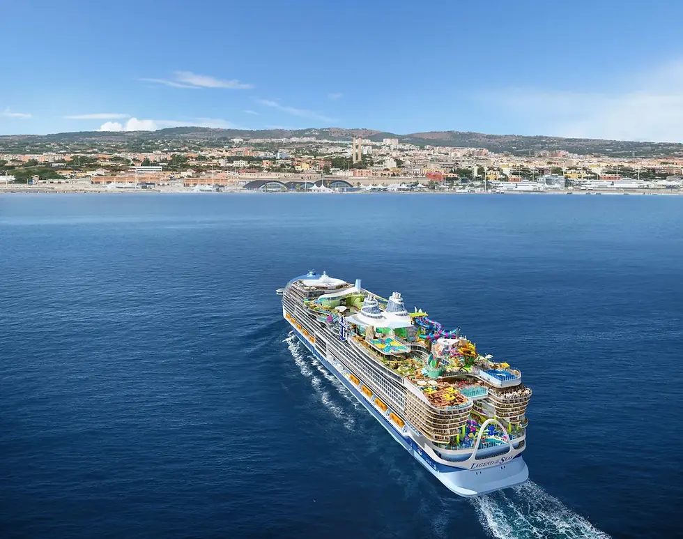 Royal Caribbean International's Legend of the Seas majestically approaches a vibrant coastal city, set against a backdrop of rolling hills and a clear blue sky.