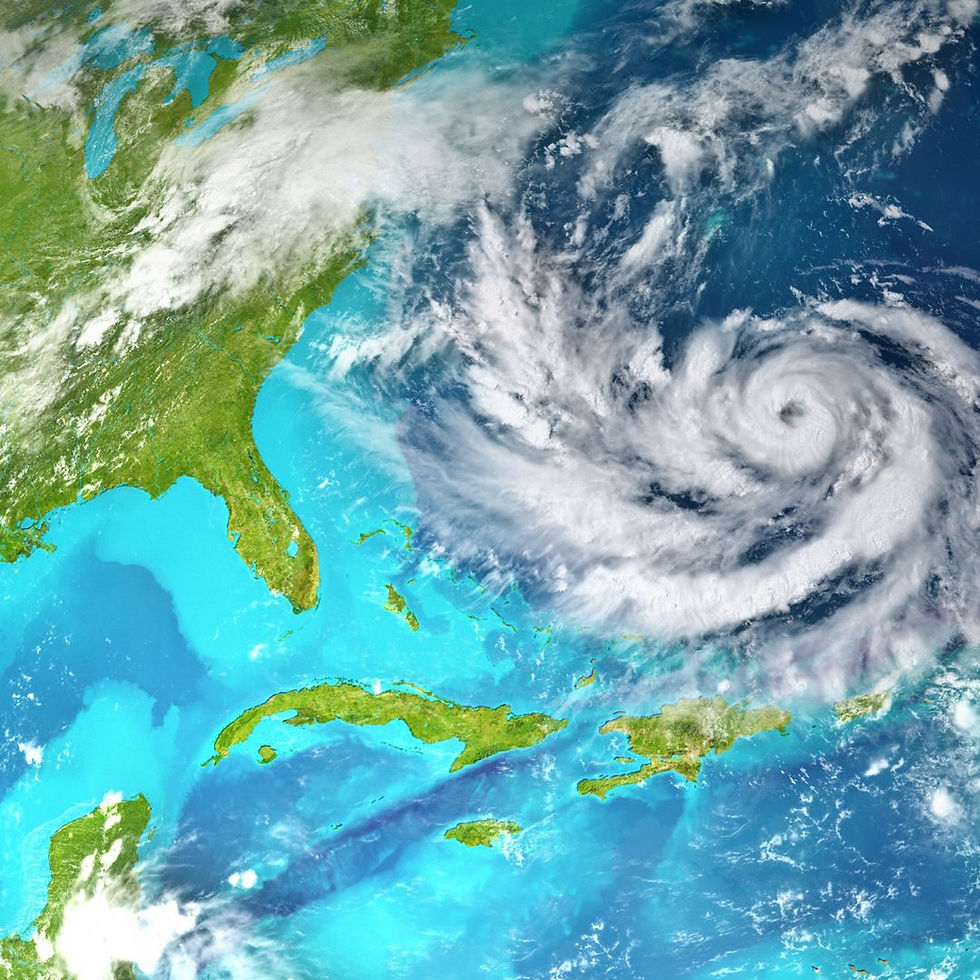 Satellite image of a swirling hurricane over the Atlantic Ocean, near the southeastern US and Caribbean islands. Vivid blues and greens.