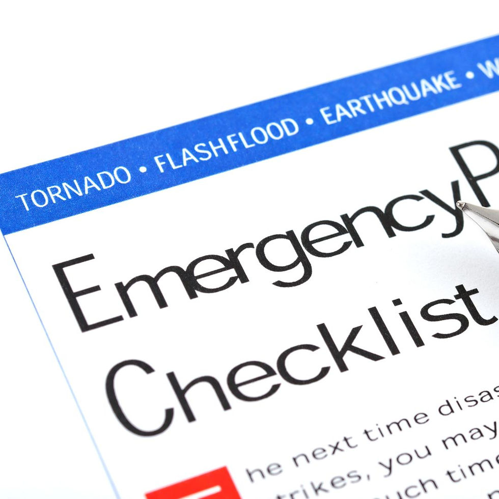 Close-up of an emergency checklist with a pen, highlighting bold text. Blue banner at top lists disasters: tornado, flash flood, earthquake.