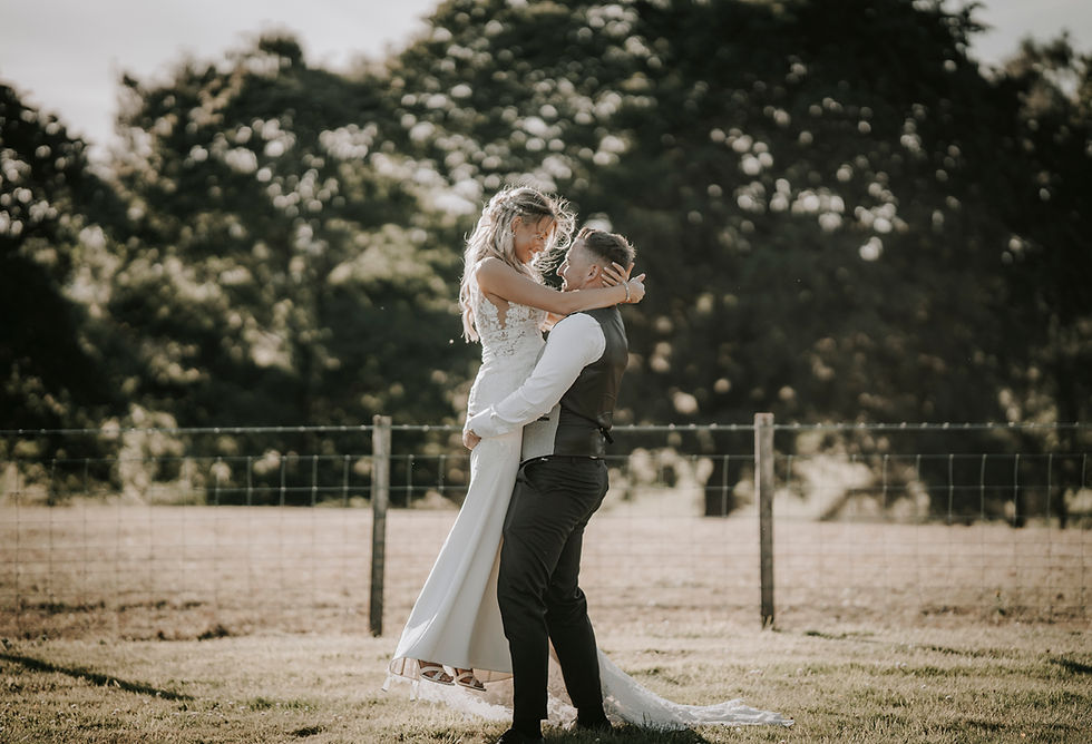 Groom lifting bride during a Cornhill Castle wedding sunset.