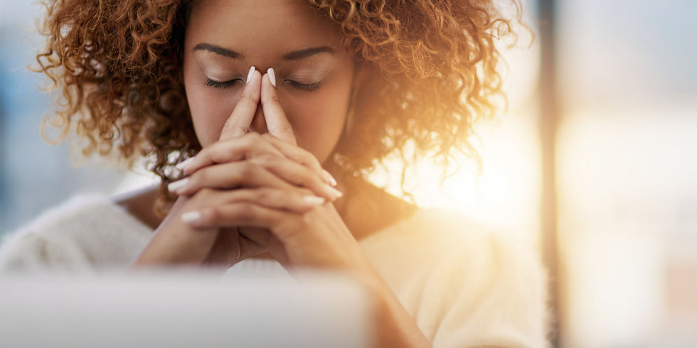 a woman leaning forward while placing her hands over face.
