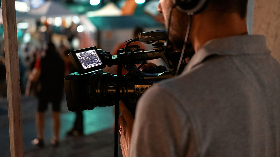 professional-cameraman-recording-poeple-watching-football-public-place-night.jpg