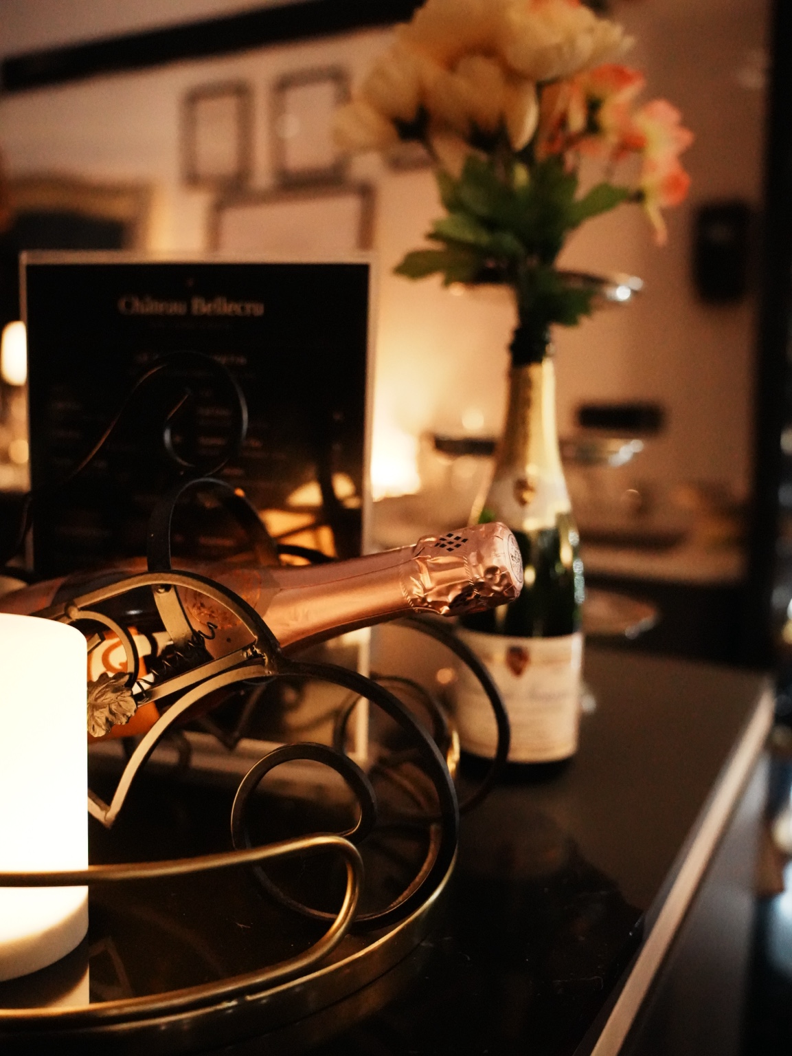 Champagne, soft light and flowers on the bar at Château Bellecru.
