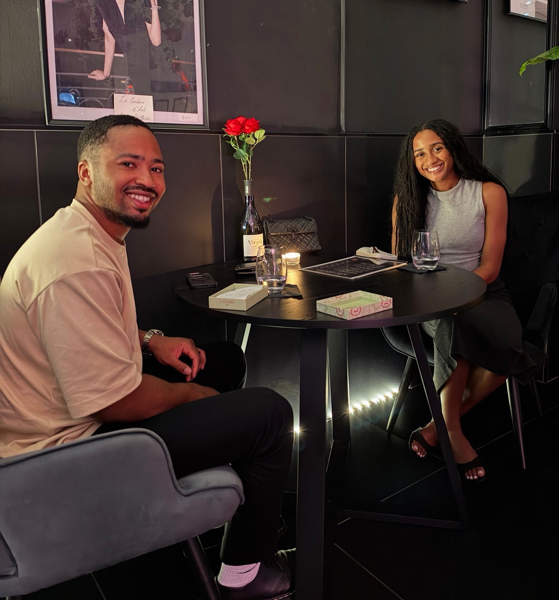 Two guests sharing a moment at a table inside Château Bellecru.