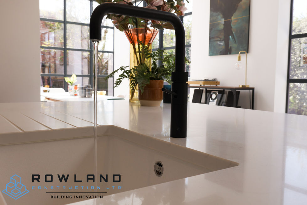 a kitchen sink with a black faucet