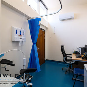a hospital room with a blue curtain