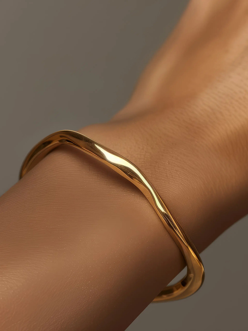 Gold custom bridal engagement ring with a wavy band.