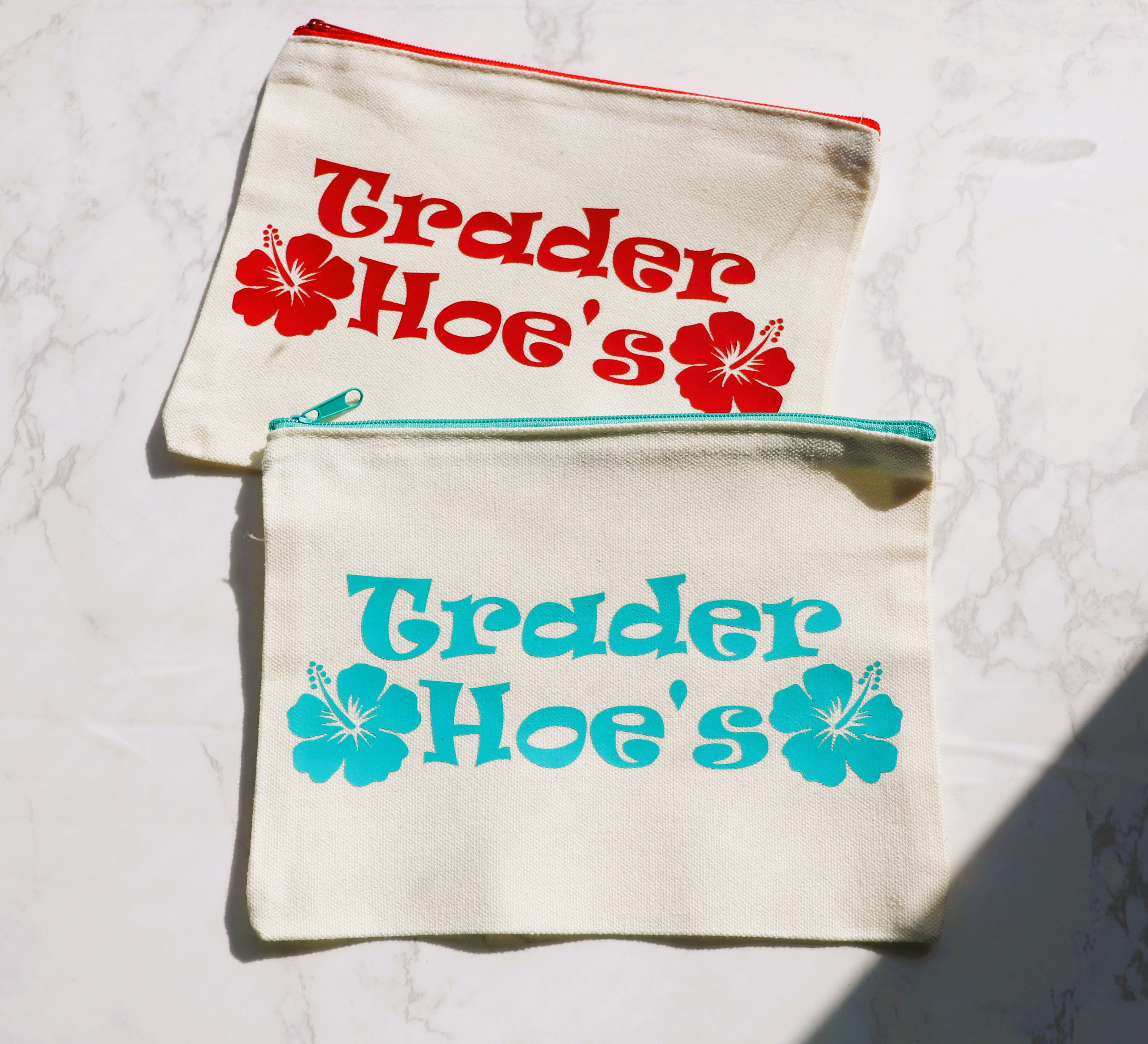 Two Trader Hoe's pouches with hibiscus