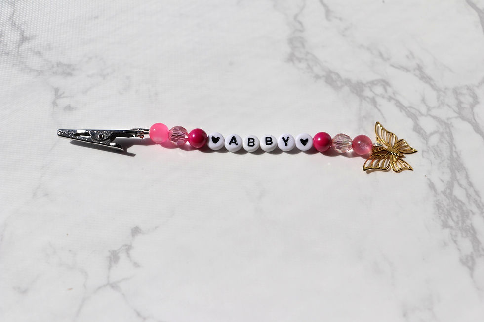 Thumbnail: Pink beaded Abby name clip with butterfly charm