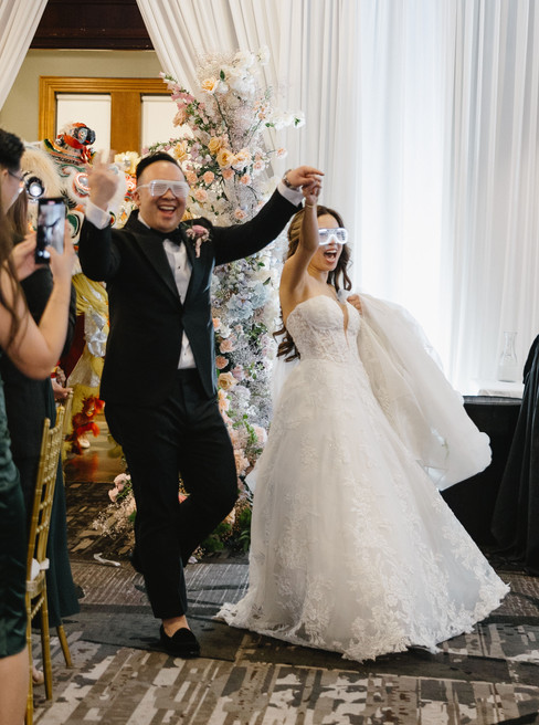 bride and groom entering wedding reception during grand entrance