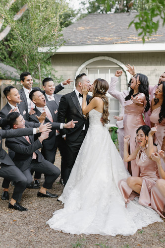 wedding party with bridesmaids in pink and groomsmen in black