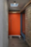 Modern entryway with bright orange door