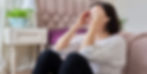 A frustrated woman with perimenopause sitting on the floor