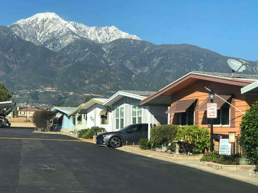 Tiny homes with different color motifs and mountain background