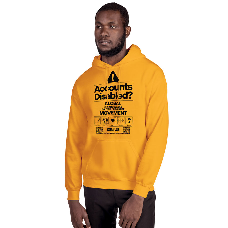 Man wearing yellow hoodie with text: Accounts Disabled, Global Justice Movement. People Over Platforms
