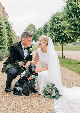 Bride & Groom smiling with their dog on their wedding day at luxury norfolk venue