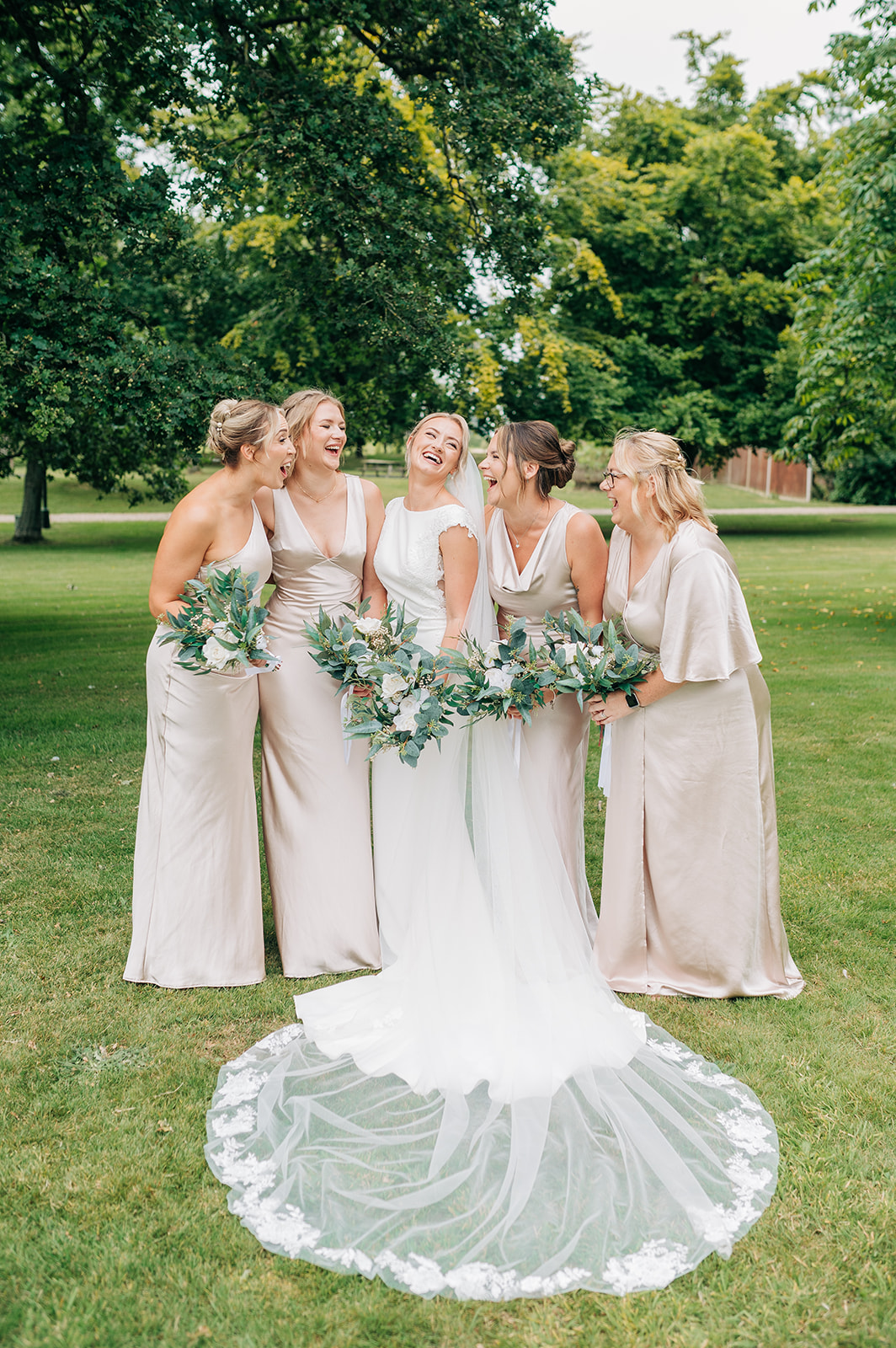 bride laughing outside with bridesmaids