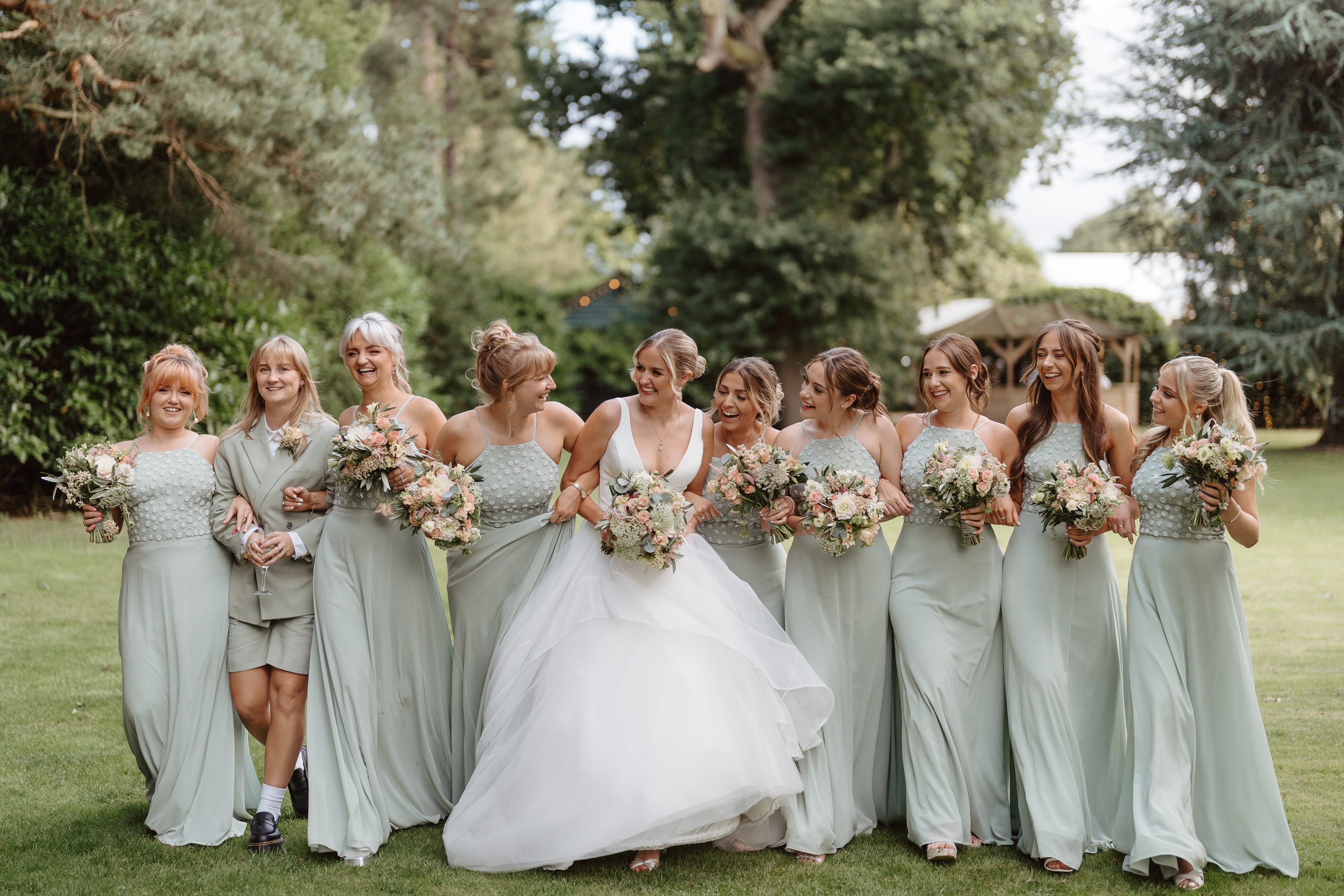 bride and bridesmaids smiling outside