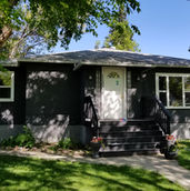 Freshly painted black residential exterior with white trim by Art-Tek Construction in Edmonton