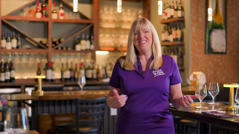 Cathy Perry, owner of the Crazy Cork Wine Bar, talking to the camera for an about us video/ video ad.