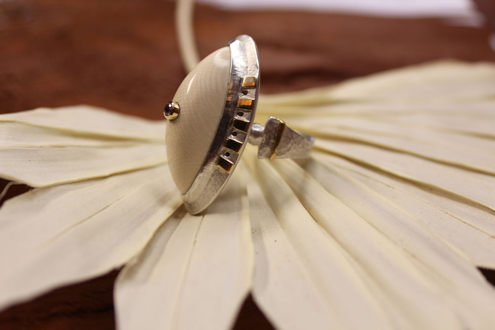 Crafted from 925 sterling silver and 18K gold, featuring fossilised mammoth bone and zirconia.