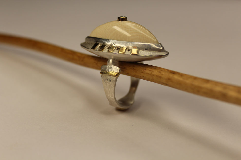 Crafted from 925 sterling silver and 18K gold, featuring fossilised mammoth bone and zirconia.