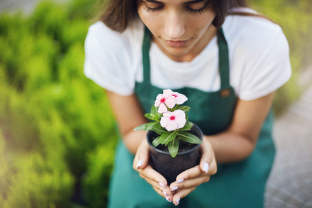 Uma mulher cultivando uma flor