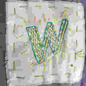 A letter w embroidered on a small piece of cloth to make a badge,