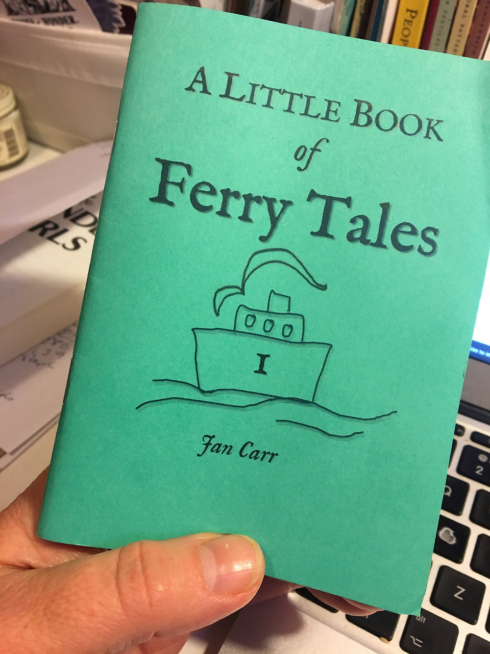 made at home sample mock up of A Little Book of Ferry Tales, green cover with title and a naive line drawing of a ferry boat.